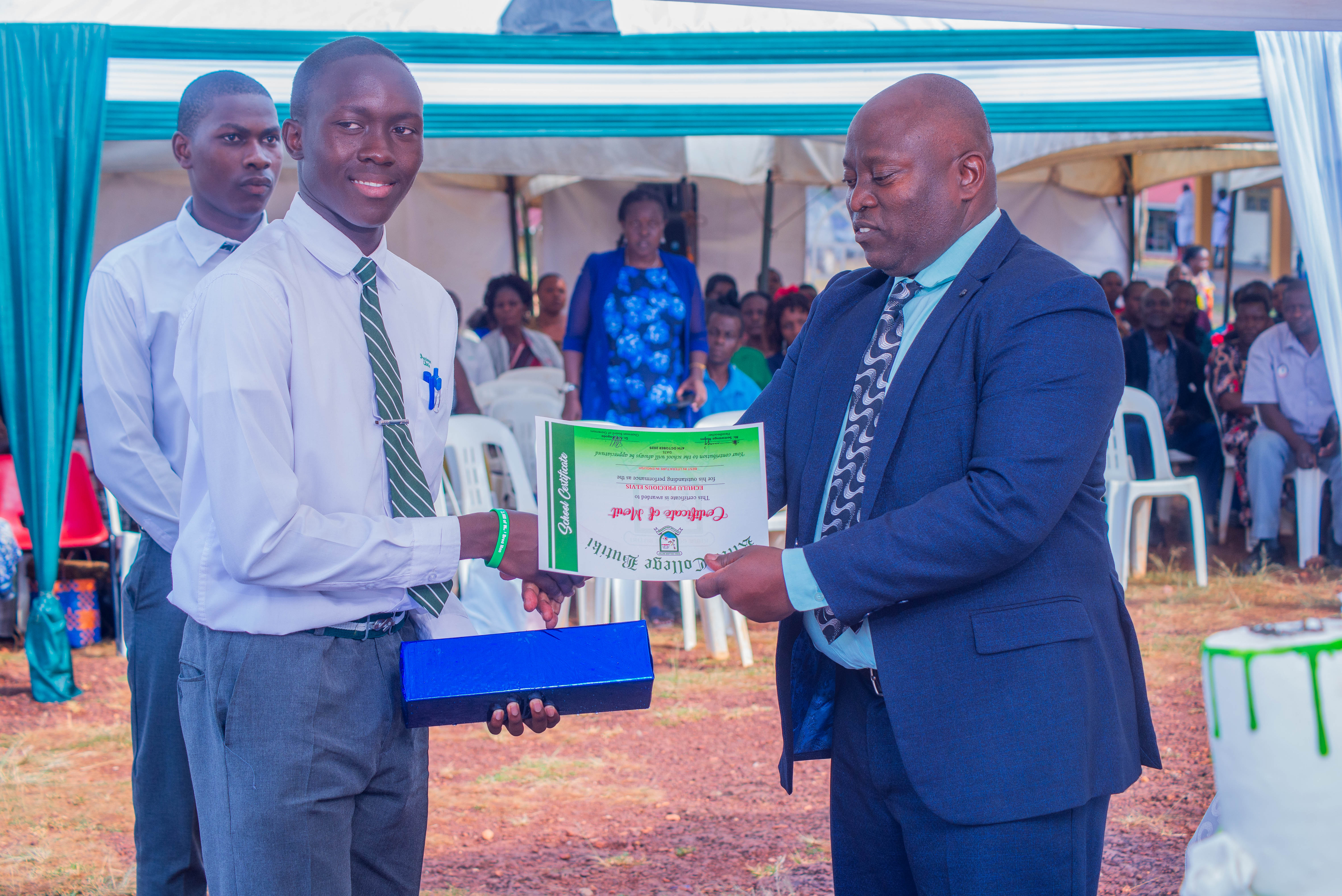 Honoring Excellence: The Headteacher awards a Certificate of Merit in recognition of outstanding achievement and exemplary dedication.